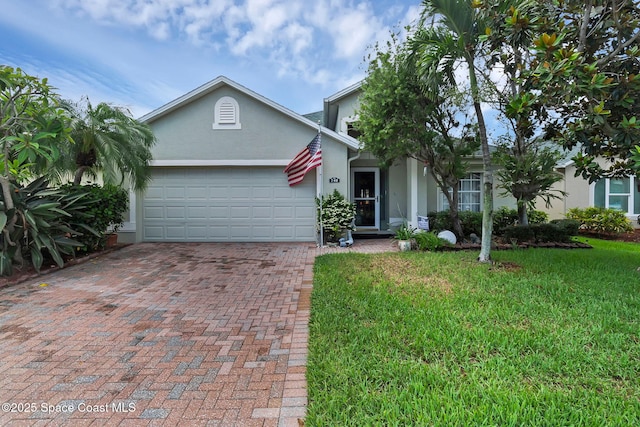 740 Indian Oaks Dr, Melbourne, FL 32901 - view of front of property featuring stucco siding, a garage, decorative driveway, and a front lawn