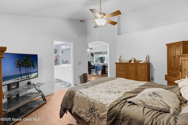 740 Indian Oaks Dr, Melbourne, FL 32901 - bedroom featuring arched walkways, light wood-style flooring, ceiling fan, ensuite bathroom, and high vaulted ceiling