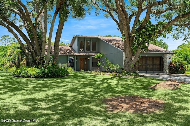 281 Caravan Ter, Sebastian, FL 32958 - view of front of home featuring a garage, driveway, and a front yard