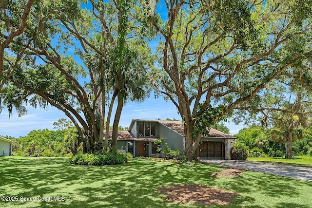 281 Caravan Ter, Sebastian, FL 32958 - mid-century home with concrete driveway, an attached garage, and a front yard