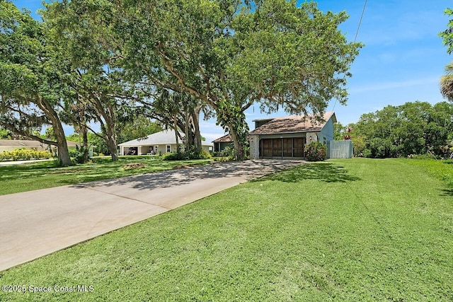 281 Caravan Ter, Sebastian, FL 32958 - view of property hidden behind natural elements featuring concrete driveway and an attached garage