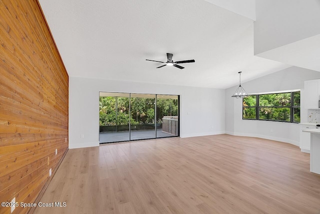 281 Caravan Ter, Sebastian, FL 32958 - unfurnished room with healthy amount of natural light, ceiling fan, light wood-type flooring, a chandelier, and lofted ceiling