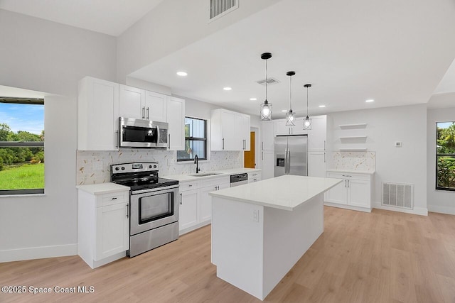 281 Caravan Ter, Sebastian, FL 32958 - kitchen featuring stainless steel appliances, light wood-type flooring, tasteful backsplash, plenty of natural light, and recessed lighting