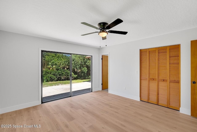 281 Caravan Ter, Sebastian, FL 32958 - unfurnished bedroom featuring access to outside, light wood-style floors, a textured ceiling, and ceiling fan
