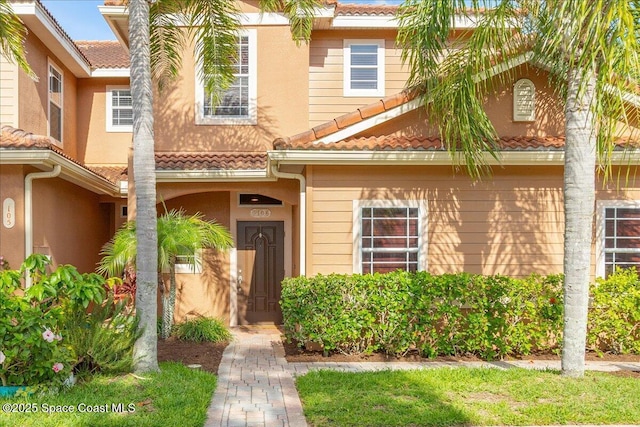 1390 Isabella Dr Unit 106, Melbourne, FL 32935 - property entrance featuring a tiled roof and stucco siding