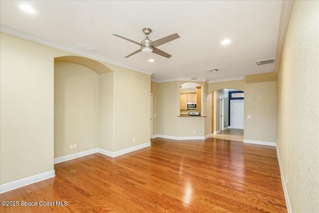 1390 Isabella Dr Unit 106, Melbourne, FL 32935 - unfurnished living room with arched walkways, ceiling fan, light wood-style flooring, recessed lighting, and ornamental molding