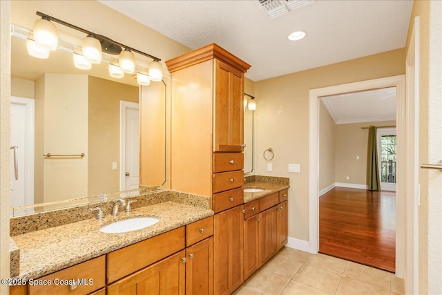 1390 Isabella Dr Unit 106, Melbourne, FL 32935 - bathroom with double vanity, tile patterned floors, and ornamental molding