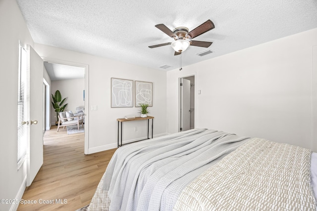 890 Yorktowne Dr, Rockledge, FL 32955 - bedroom with light wood-style flooring, a textured ceiling, and a ceiling fan
