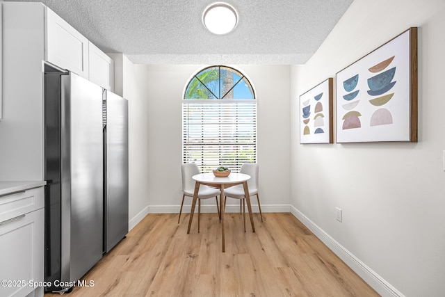 890 Yorktowne Dr, Rockledge, FL 32955 - dining area with a textured ceiling and light wood-type flooring