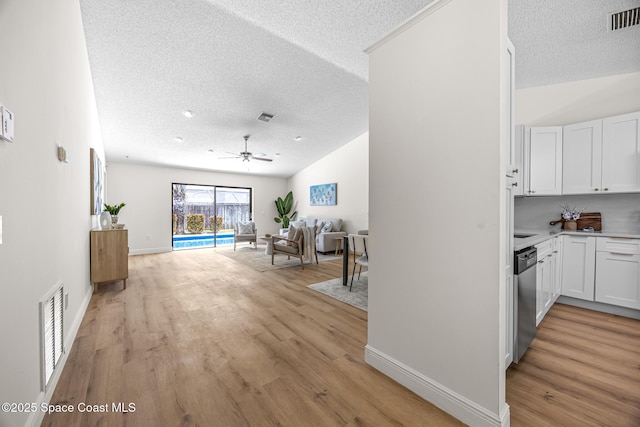 890 Yorktowne Dr, Rockledge, FL 32955 - hall with a textured ceiling, light wood-type flooring, and lofted ceiling