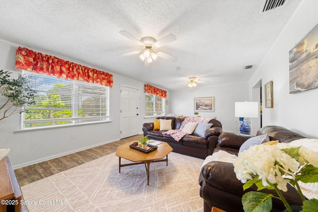 1242 Creel Rd NE, Palm Bay, FL 32905 - living area featuring ceiling fan, wood finished floors, and a textured ceiling