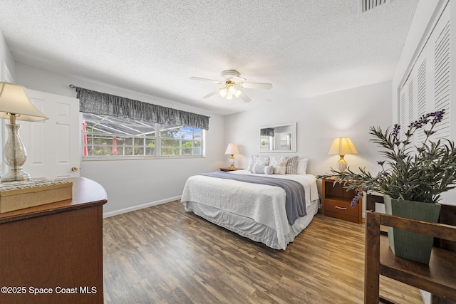 1242 Creel Rd NE, Palm Bay, FL 32905 - bedroom featuring a textured ceiling, wood finished floors, and a ceiling fan