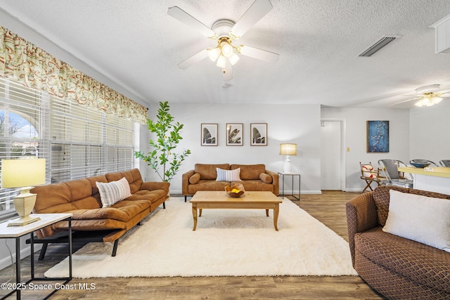 1242 Creel Rd NE, Palm Bay, FL 32905 - living area with ceiling fan, wood finished floors, and a textured ceiling