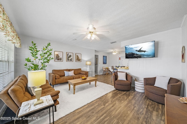 1242 Creel Rd NE, Palm Bay, FL 32905 - living room featuring ceiling fan, wood finished floors, and a textured ceiling