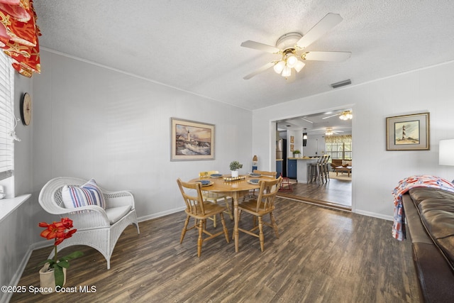 1242 Creel Rd NE, Palm Bay, FL 32905 - dining area with a ceiling fan, wood finished floors, a textured ceiling, and ornamental molding