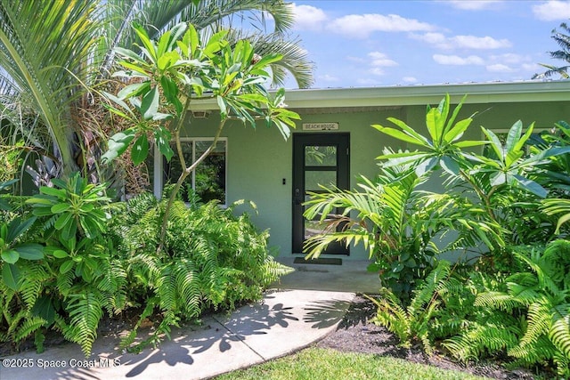 212 Ormond Dr, Indialantic, FL 32903 - property entrance with stucco siding