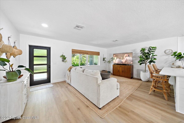 212 Ormond Dr, Indialantic, FL 32903 - living room with light wood-style flooring, a textured ceiling, and recessed lighting