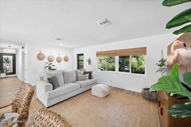 212 Ormond Dr, Indialantic, FL 32903 - living area with wood finished floors and a textured ceiling