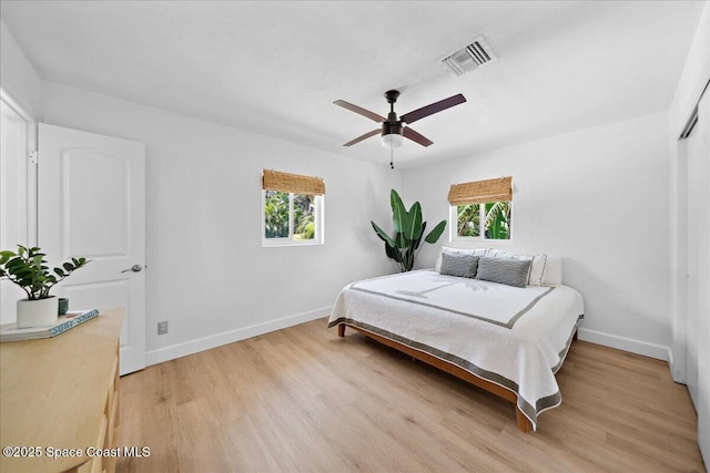 212 Ormond Dr, Indialantic, FL 32903 - bedroom with multiple windows, light wood finished floors, and ceiling fan