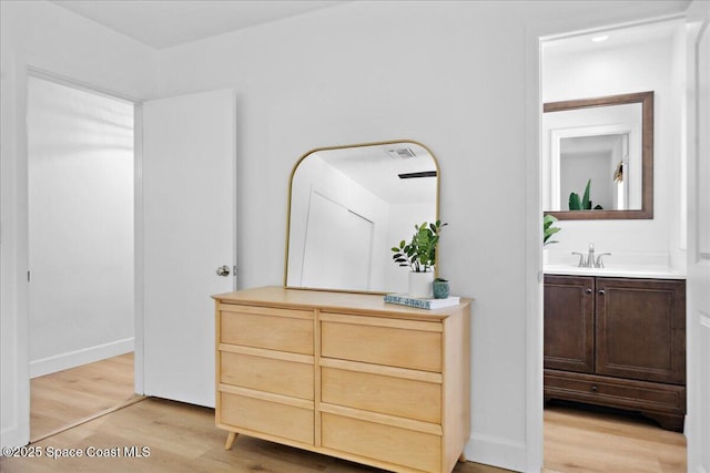 212 Ormond Dr, Indialantic, FL 32903 - hallway with light wood-style floors and a sink
