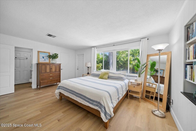 212 Ormond Dr, Indialantic, FL 32903 - bedroom with light wood finished floors and a textured ceiling