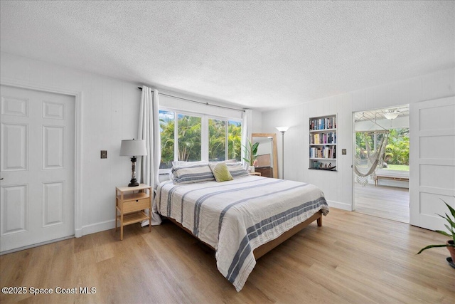 212 Ormond Dr, Indialantic, FL 32903 - bedroom featuring a textured ceiling and light wood finished floors