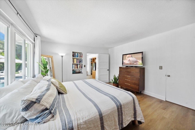 212 Ormond Dr, Indialantic, FL 32903 - bedroom with a textured ceiling and light wood-type flooring
