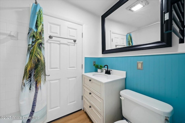 212 Ormond Dr, Indialantic, FL 32903 - bathroom featuring vanity, a shower with curtain, and a wainscoted wall