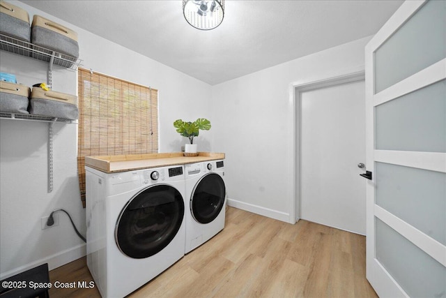 212 Ormond Dr, Indialantic, FL 32903 - washroom with light wood-style flooring and washing machine and dryer