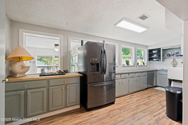 1949 36th Ave, Vero Beach, FL 32960 - kitchen featuring appliances with stainless steel finishes, light wood-type flooring, a textured ceiling, open shelves, and gray cabinets