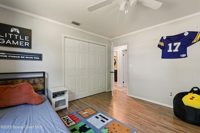 1949 36th Ave, Vero Beach, FL 32960 - bedroom with wood finished floors, a closet, ornamental molding, and a ceiling fan