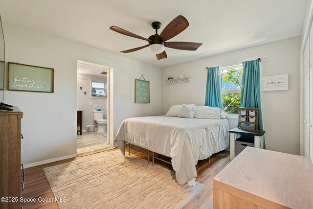 1949 36th Ave, Vero Beach, FL 32960 - bedroom featuring wood finished floors, multiple windows, ensuite bathroom, and a ceiling fan