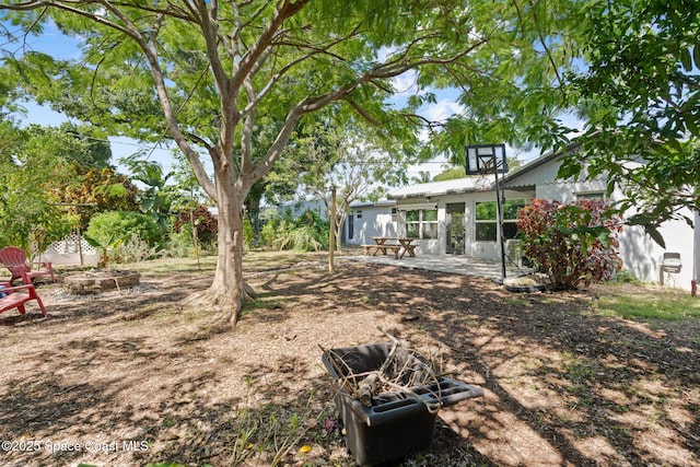 1949 36th Ave, Vero Beach, FL 32960 - view of yard featuring a patio and an outdoor fire pit
