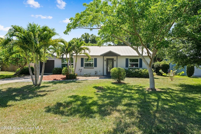 1949 36th Ave, Vero Beach, FL 32960 - single story home with a garage, stucco siding, a front yard, a metal roof, and concrete driveway
