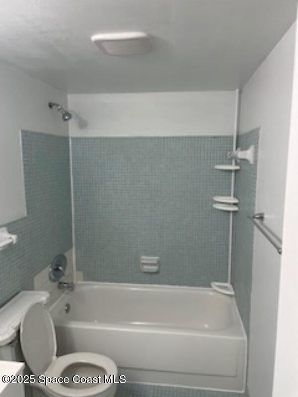 230 Columbia Dr Unit 208, Cape Canaveral, FL 32920 - full bathroom featuring bathtub / shower combination and tile walls