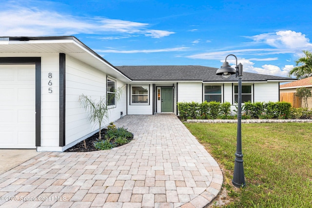 865 Southern Pine Trl, Rockledge, FL 32955 - view of front of house featuring a front lawn and an attached garage