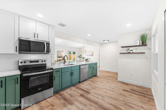 865 Southern Pine Trl, Rockledge, FL 32955 - kitchen featuring stainless steel appliances, green cabinetry, light countertops, decorative backsplash, and recessed lighting