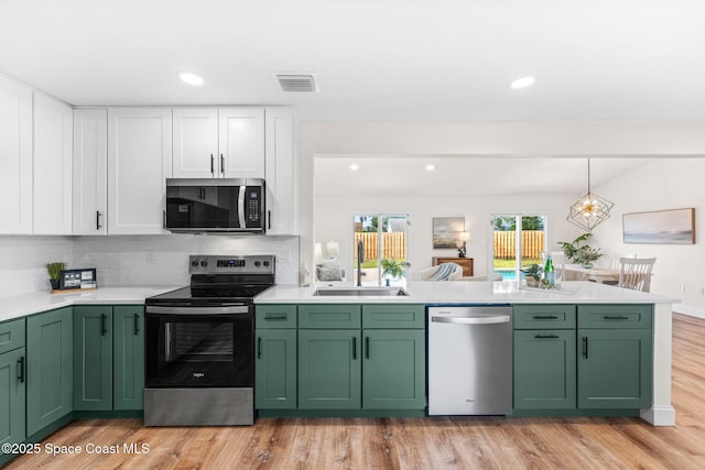 865 Southern Pine Trl, Rockledge, FL 32955 - kitchen featuring appliances with stainless steel finishes, green cabinetry, a peninsula, and recessed lighting