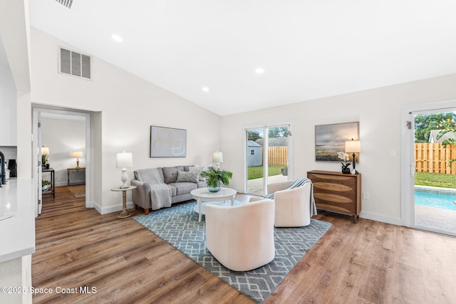 865 Southern Pine Trl, Rockledge, FL 32955 - living area with wood finished floors, lofted ceiling, and recessed lighting