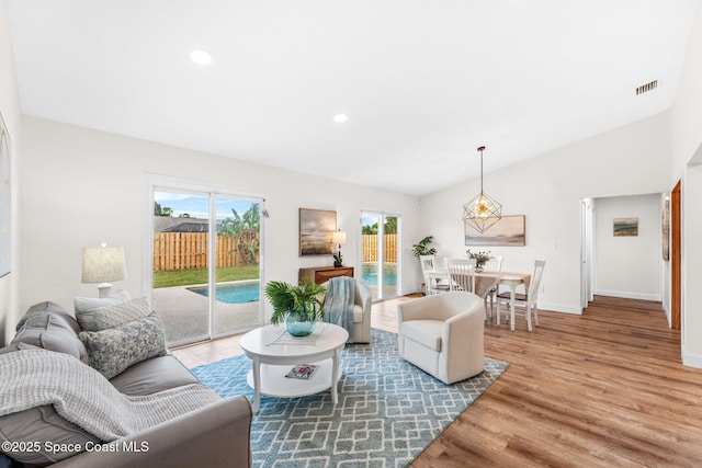 865 Southern Pine Trl, Rockledge, FL 32955 - living room featuring wood finished floors, vaulted ceiling, and recessed lighting