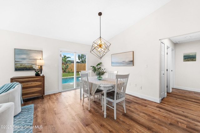 865 Southern Pine Trl, Rockledge, FL 32955 - dining room with wood finished floors, vaulted ceiling, and a chandelier