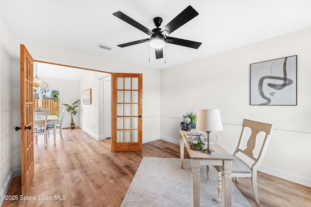 865 Southern Pine Trl, Rockledge, FL 32955 - office area with french doors, light wood finished floors, a ceiling fan, and a chandelier