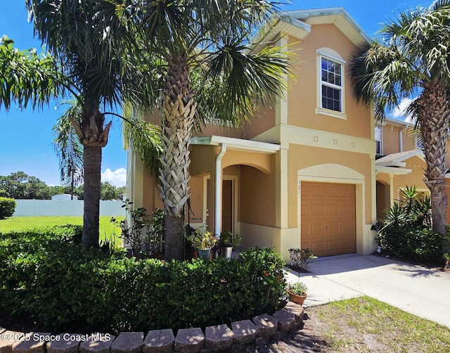 2735 Revolution St Unit 101, Melbourne, FL 32935 - view of front of property featuring stucco siding, an attached garage, and driveway