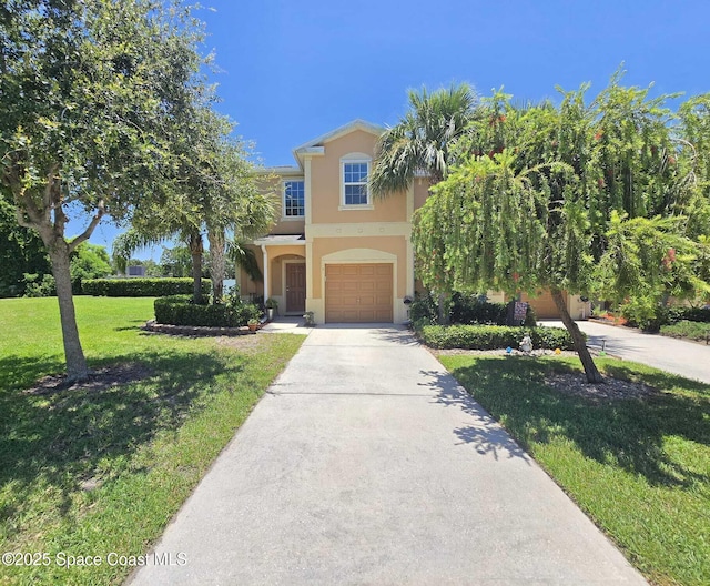 2735 Revolution St Unit 101, Melbourne, FL 32935 - view of front of property featuring stucco siding, concrete driveway, a garage, and a front yard
