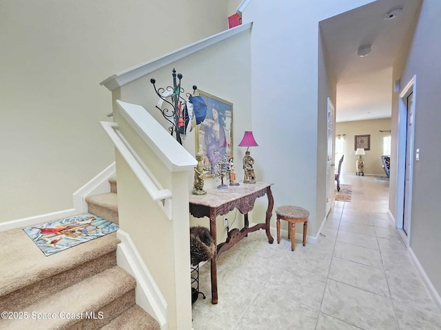 2735 Revolution St Unit 101, Melbourne, FL 32935 - hallway with stairway and light tile patterned floors