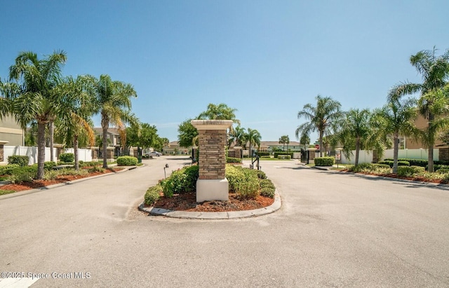 2735 Revolution St Unit 101, Melbourne, FL 32935 - view of asphalt street with curbs, a gated entry, and a residential view