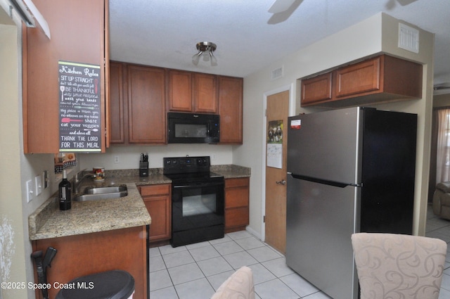 2938 Chipper Dr NE, Palm Bay, FL 32905 - kitchen with black appliances, light tile patterned flooring, brown cabinetry, and a ceiling fan