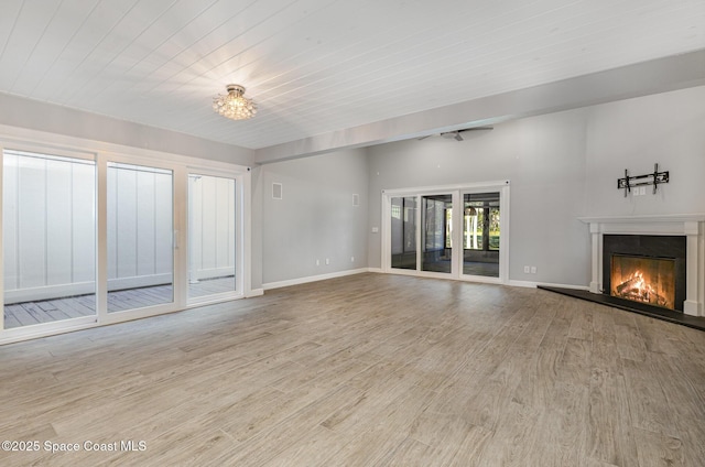 1250 Admiralty Blvd, Rockledge, FL 32955 - unfurnished living room featuring a glass covered fireplace, wood finished floors, and a chandelier