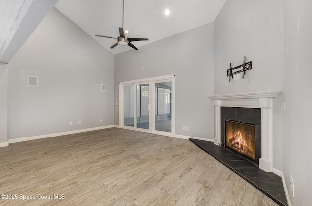 1250 Admiralty Blvd, Rockledge, FL 32955 - unfurnished living room featuring high vaulted ceiling, a premium fireplace, wood finished floors, ceiling fan, and recessed lighting