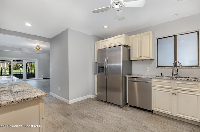 1250 Admiralty Blvd, Rockledge, FL 32955 - kitchen with stainless steel appliances, ceiling fan, light wood-style floors, light stone countertops, and recessed lighting